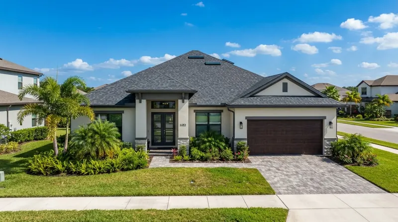 Hip roof with dark gray architectural shingles on a Southwest Florida home